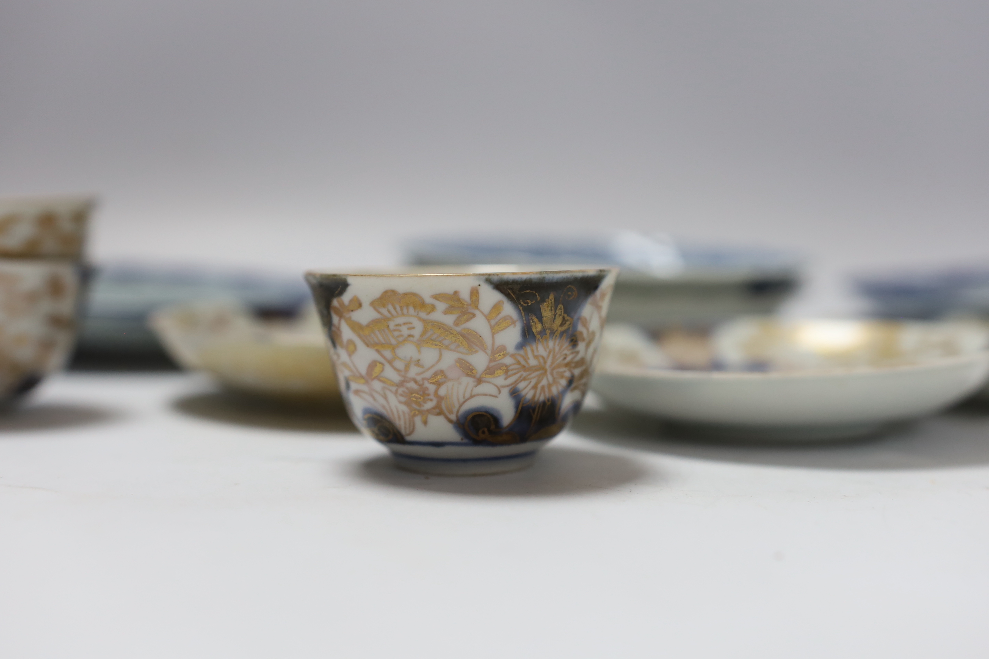 Four 18th century Japanese teabowls with three matching saucers, two 19th century Chinese cafe au lait glazed teabowls and four Chinese blue and white small dishes